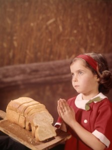 h-armstrong-roberts-young-girl-saying-prayer-praying-loaf-bread-wheat-field-background