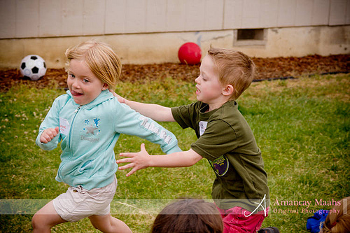 boy chasing girl in duck, duck, goose game