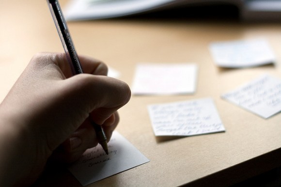 hand writing post-it reminders